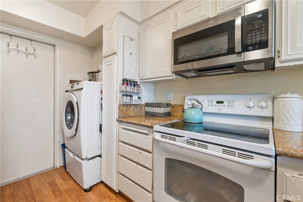 567 Avenida Adobe San Clemente, CA 92672 - Photo 16 of 33 a kitchen with stainless steel appliances white cabinets and a stove top oven