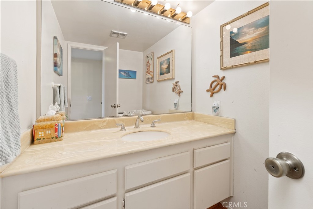 567 Avenida Adobe San Clemente, CA 92672 - Photo 17 of 33 a bathroom with a granite countertop sink and a mirror