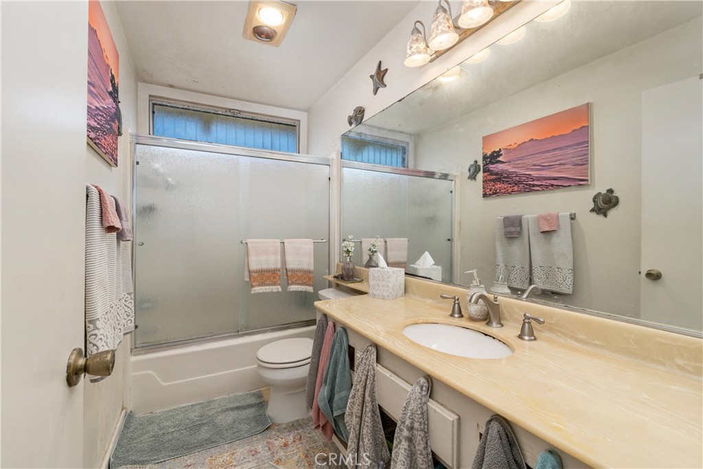 567 Avenida Adobe San Clemente, CA 92672 - Photo 22 of 33 a bathroom with a granite countertop sink a toilet a mirror and shower