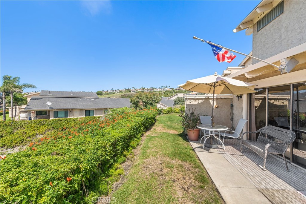 567 Avenida Adobe San Clemente, CA 92672 - Photo 28 of 33 a view of a patio with table and chairs under an umbrella