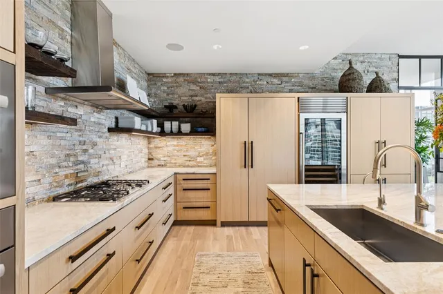 a kitchen with stainless steel appliances granite countertop a sink stove and cabinets