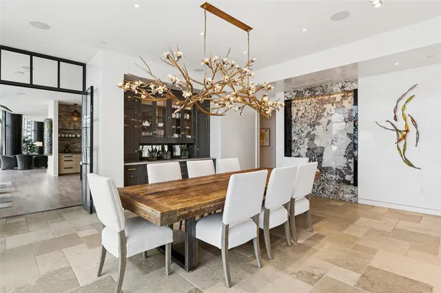 a view of a dining room with furniture and a potted plant