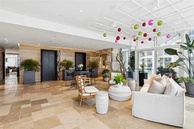 a living room with furniture a potted plant and a table