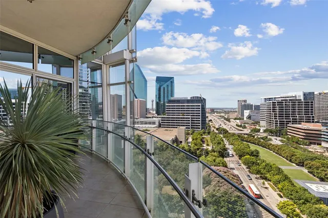 a view of a patio with table and chairs potted plants and large tree