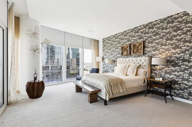 a spacious bedroom with a bed and a couch