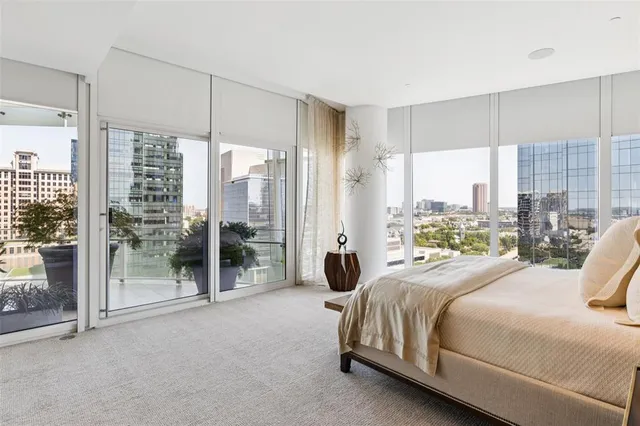 a large bedroom with a large bed and a large window