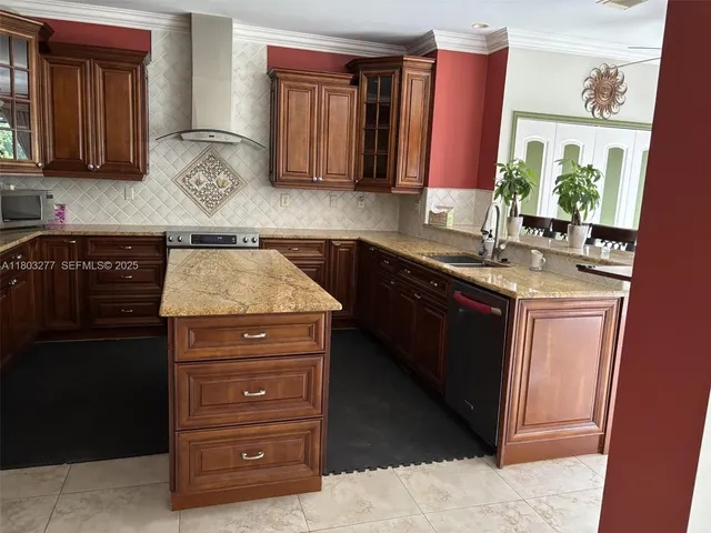 a kitchen with a sink a stove and cabinets