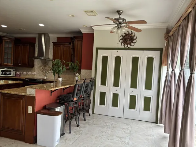 a view of a kitchen with a dining table chairs and cabinets