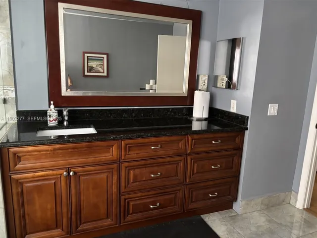 a bathroom with a sink and a mirror