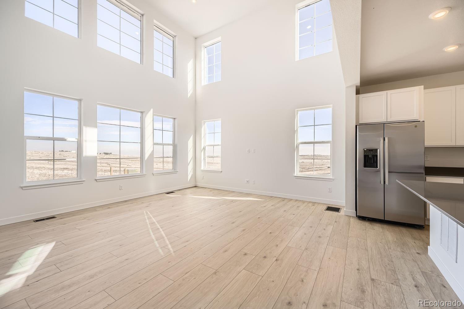 907 Congress Place Elizabeth, CO 80107 - Photo 2 of 19 a view of an empty room with a window and wooden floor