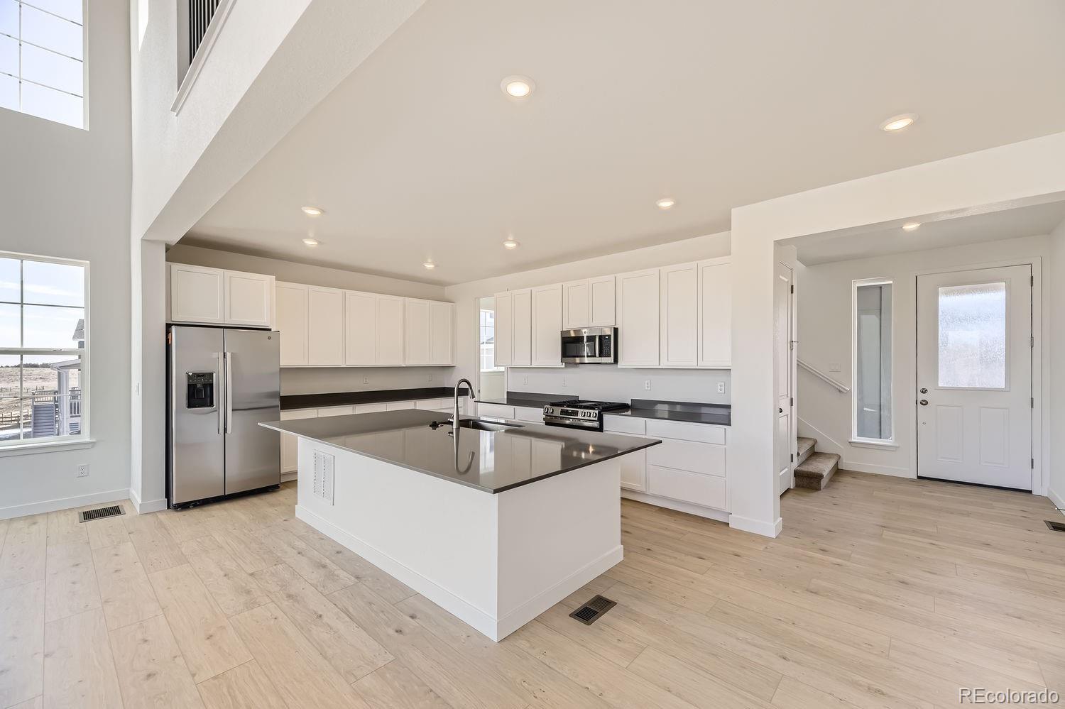 907 Congress Place Elizabeth, CO 80107 - Photo 4 of 19 a kitchen with stainless steel appliances granite countertop a sink and a refrigerator