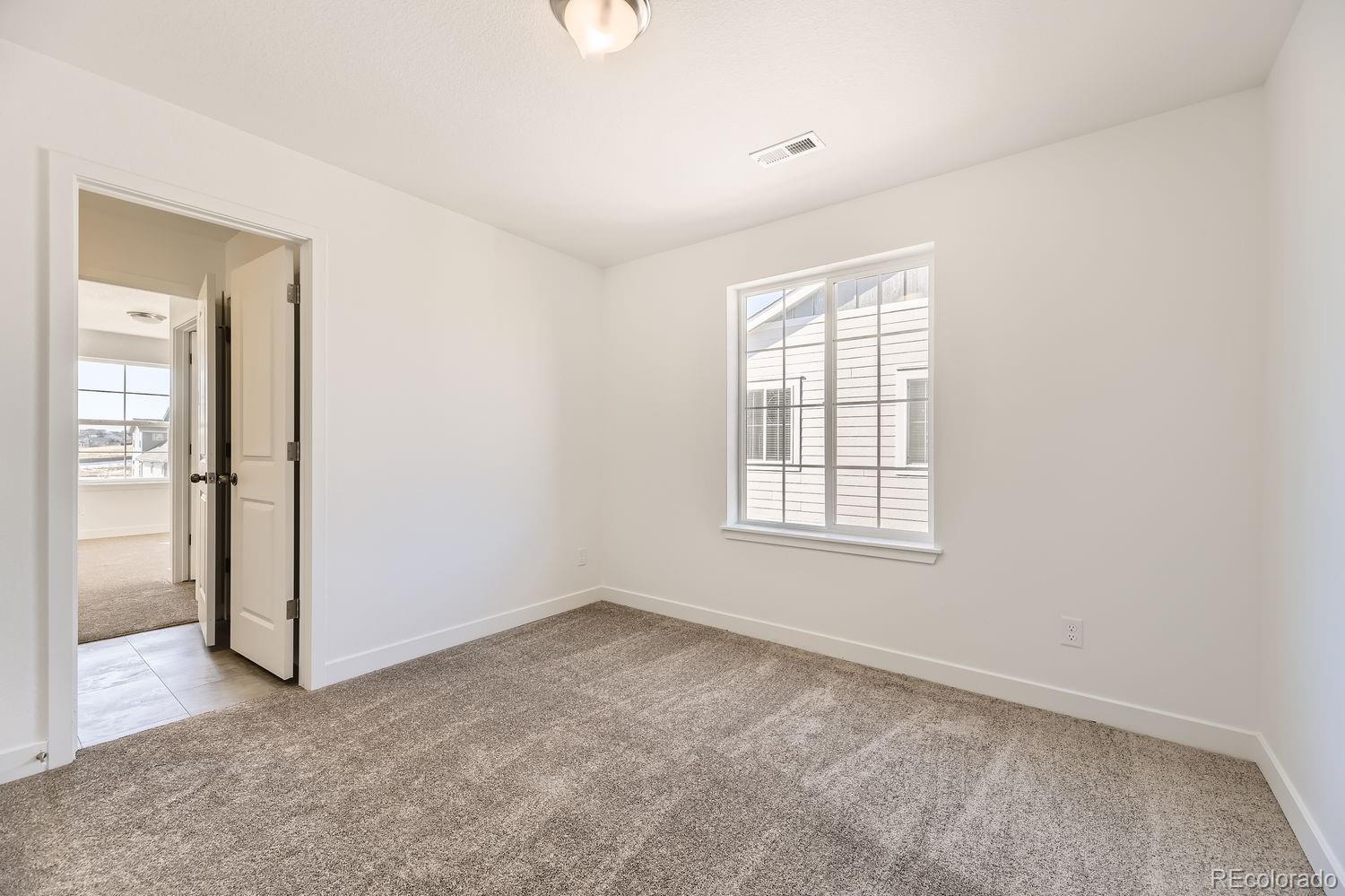 907 Congress Place Elizabeth, CO 80107 - Photo 9 of 19 an empty room with windows