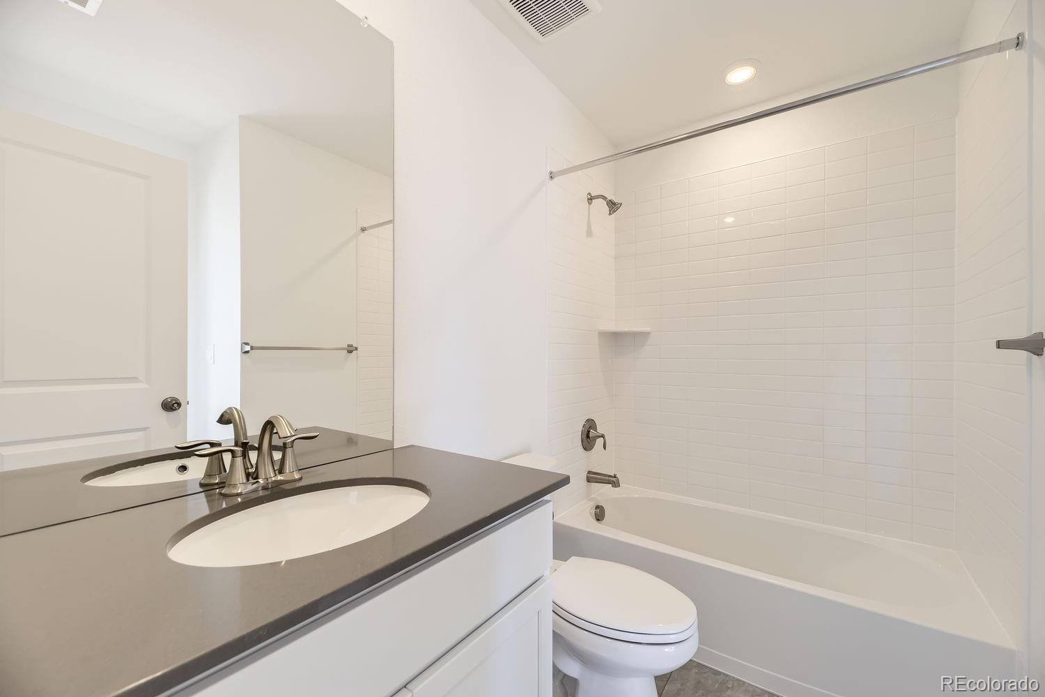 907 Congress Place Elizabeth, CO 80107 - Photo 10 of 19 a bathroom with a granite countertop sink toilet and shower