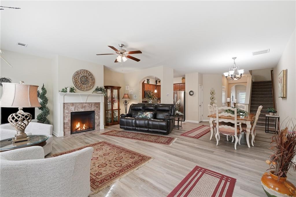 608 Myers Gate Road Ball Ground, GA 30107 - Photo 3 of 31 a living room with furniture a clock and a fireplace