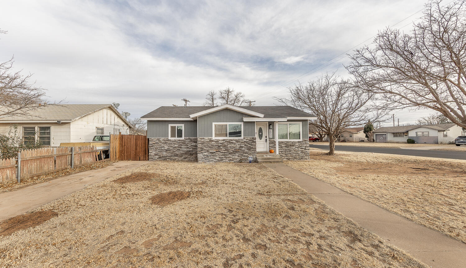 a view of house with yard and sitting area