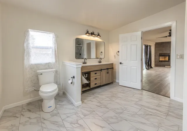 a bathroom with a toilet sink and mirror
