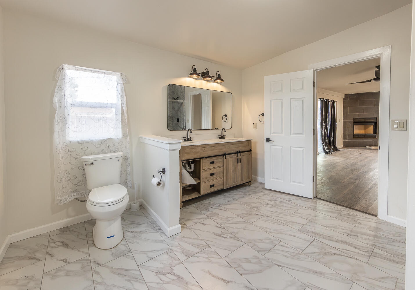2002 65th Street Lubbock, TX 79412 - Photo 12 of 25 a bathroom with a toilet sink and mirror