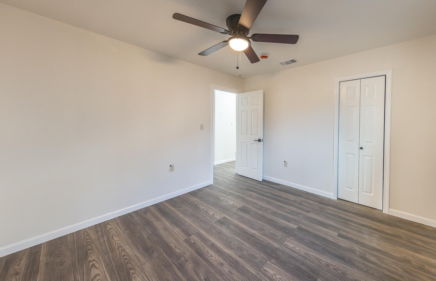 2002 65th Street Lubbock, TX 79412 - Photo 15 of 25 an empty room with wooden floor ceiling fan and window