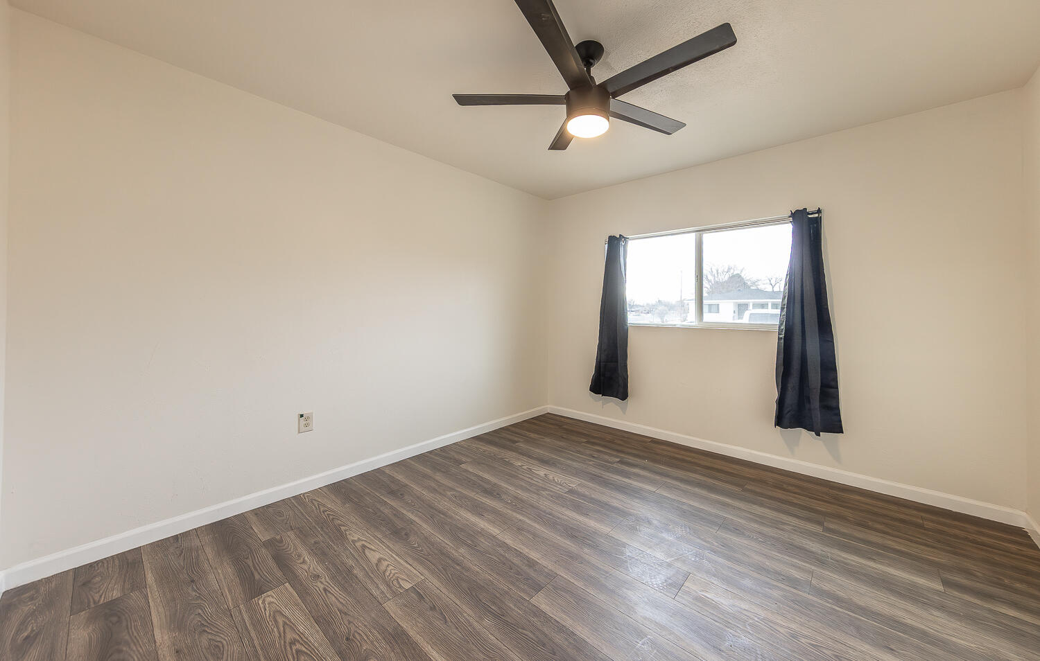 2002 65th Street Lubbock, TX 79412 - Photo 18 of 25 an empty room with wooden floor and windows