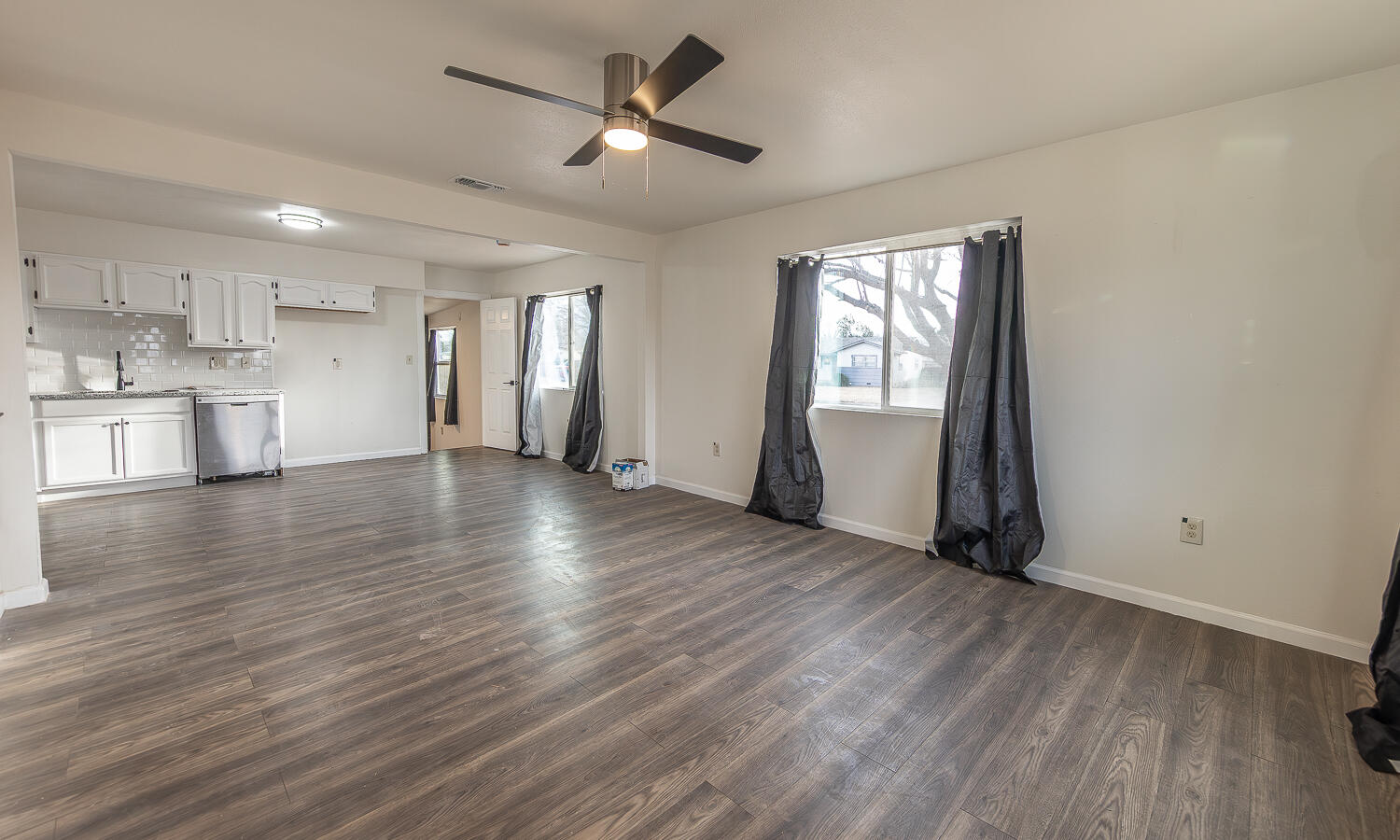 2002 65th Street Lubbock, TX 79412 - Photo 2 of 25 a view of an empty room with window and wooden floor