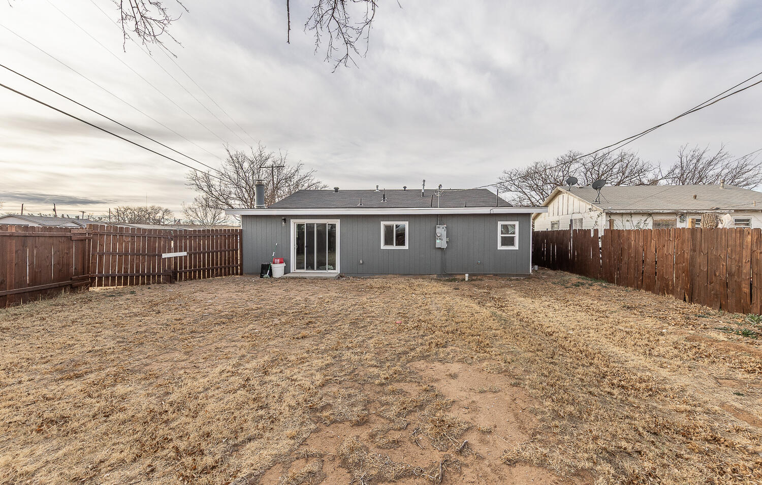 2002 65th Street Lubbock, TX 79412 - Photo 22 of 25 a front view of a house with a yard and a wooden fence