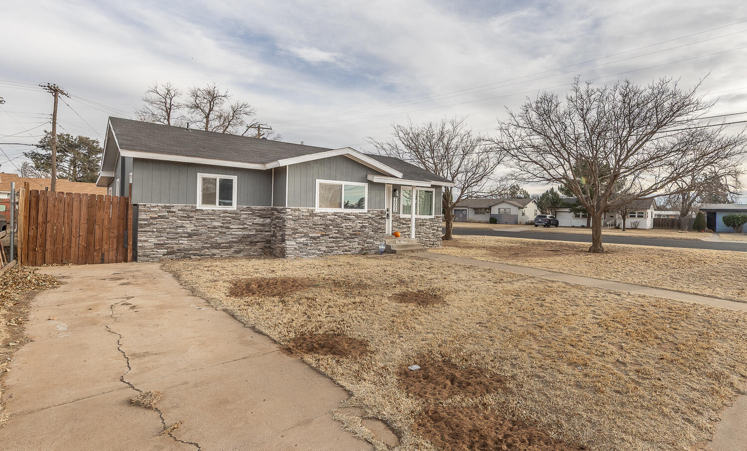 2002 65th Street Lubbock, TX 79412 - Photo 25 of 25 a front view of a house with a yard and garage