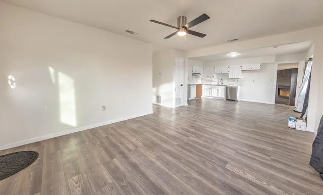 a view of a kitchen with wooden floor and a window