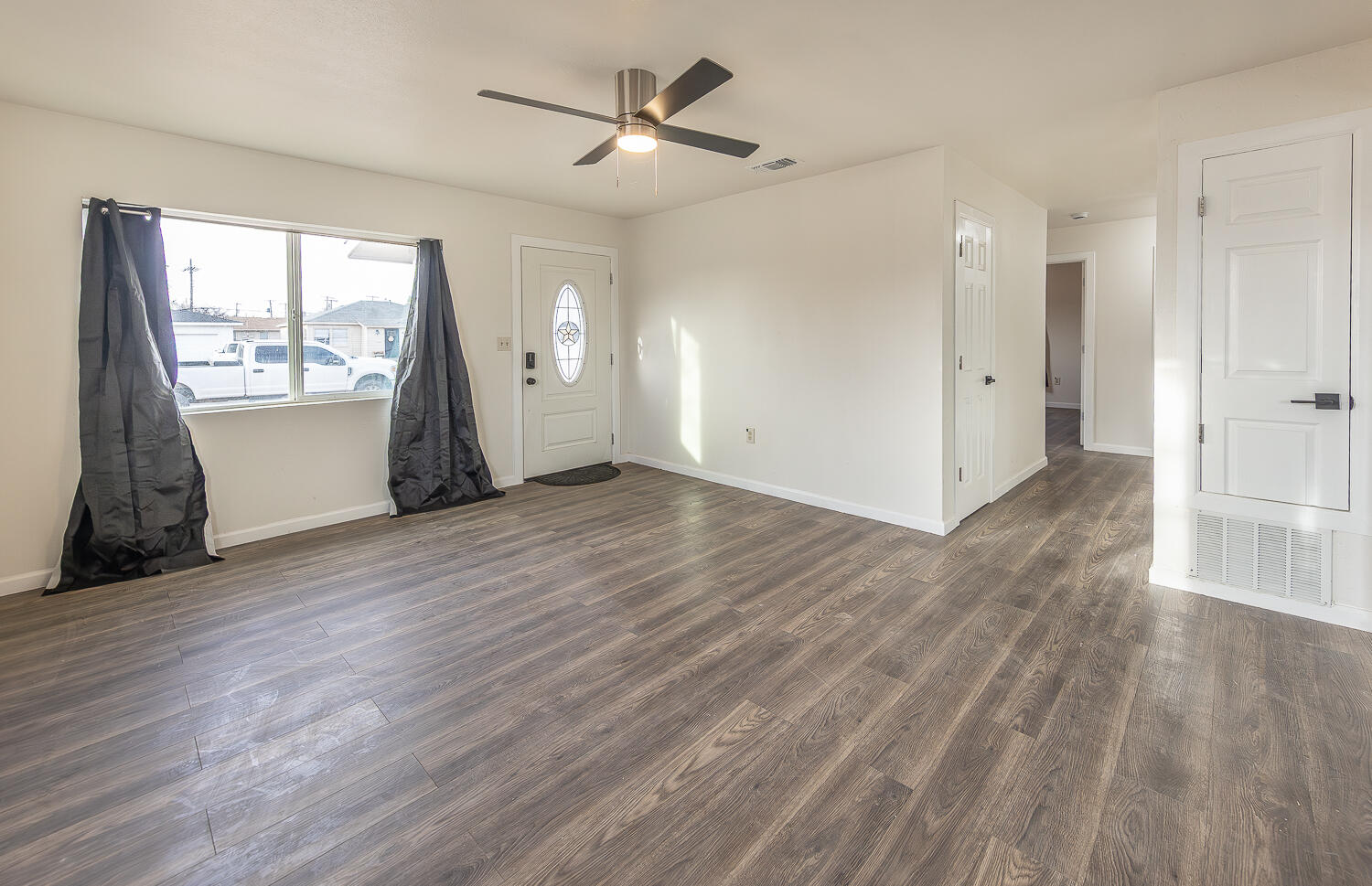 2002 65th Street Lubbock, TX 79412 - Photo 5 of 25 an empty room with wooden floor and windows