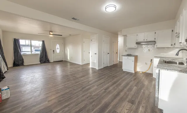 a view of kitchen with sink and wooden floor