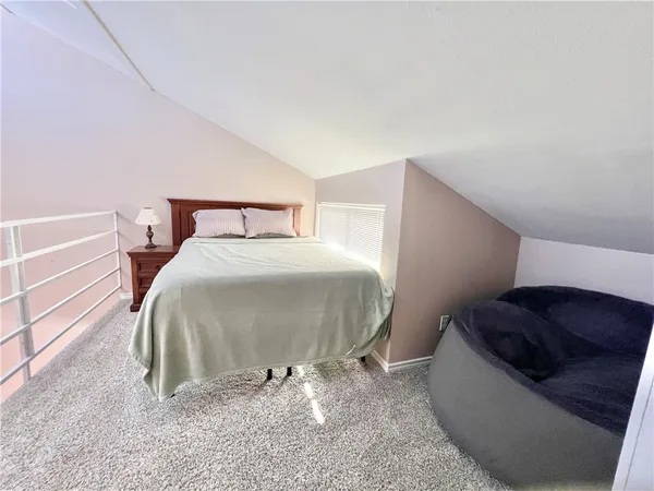 a bed room with a bed and a chair