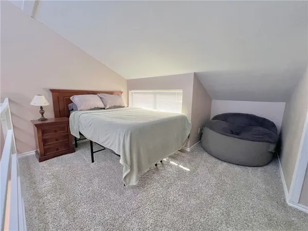 a bedroom with a bed and a chair