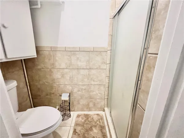 a white toilet sitting next to a small sink