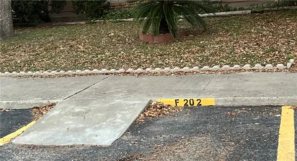 a view of a brick house with a large window and plants