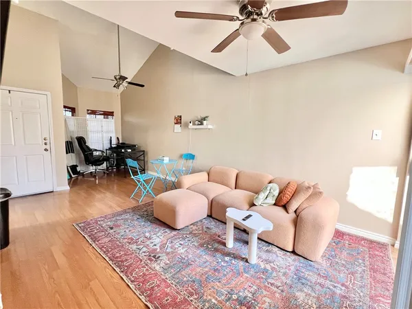 a living room with furniture and wooden floor