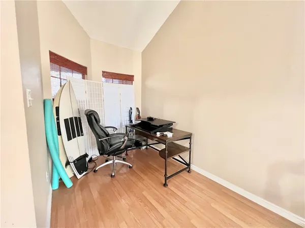 a view of a workspace with furniture and a window