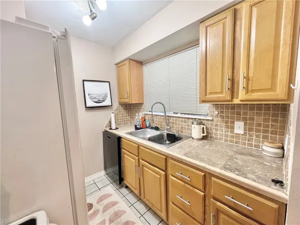 a kitchen with a sink cabinets and window