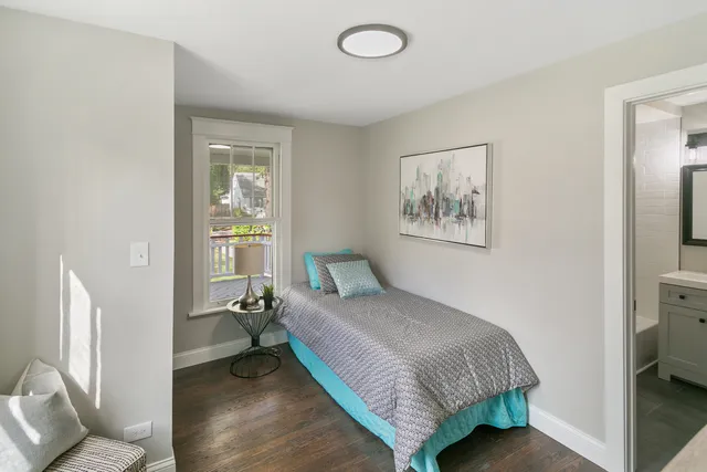 a bedroom with a bed and a painting on the wall