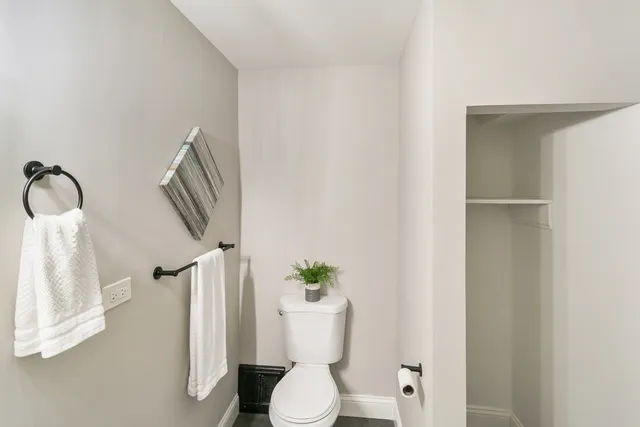 a white toilet sitting next to a bathroom sink