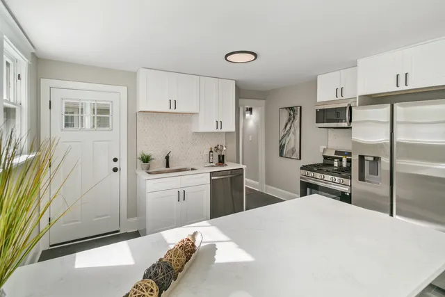 a kitchen with a refrigerator sink and stove