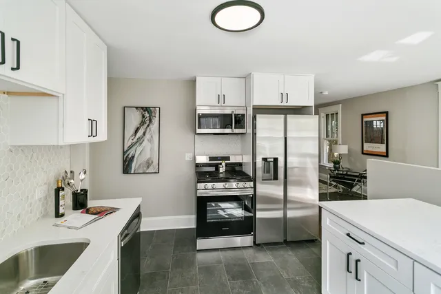 a kitchen with stainless steel appliances a refrigerator sink and stove