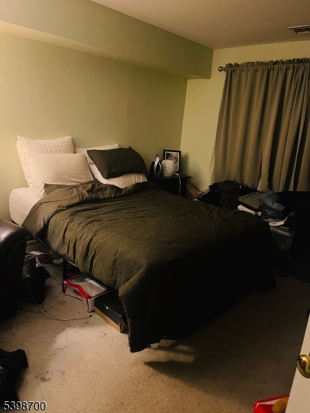 3 Quartz Lane, Unit 3 Paterson, NJ 07501 - Photo 6 of 10 a bed sitting in a bedroom next to a window