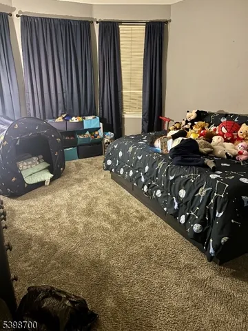 a bedroom with bed and window