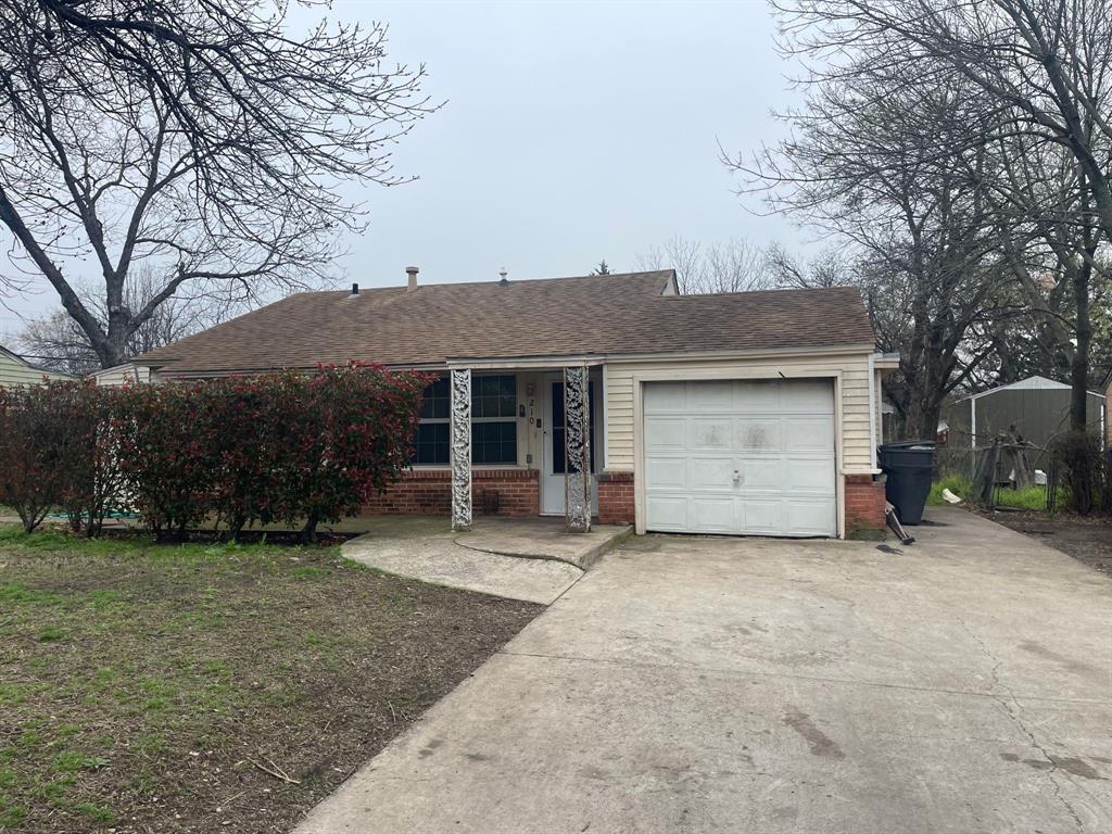210 Halsey Street Dallas, TX 75224 - Photo 1 of 1 a front view of a house with a garden and trees