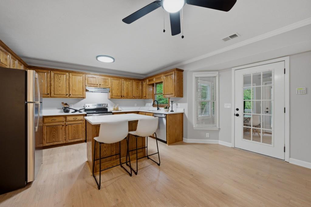542 Knox Chapel Road Social Circle, GA 30025 - Photo 6 of 52 a kitchen with a table chairs refrigerator and cabinets