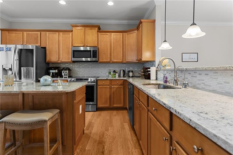 2744 Blakely Drive Northeast Suwanee, GA 30024 - Photo 15 of 45 a kitchen with a sink stove and cabinets