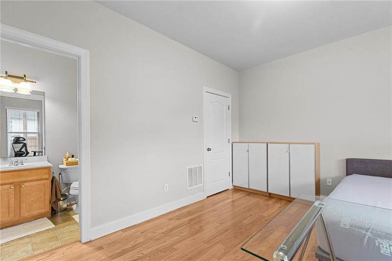 2744 Blakely Drive Northeast Suwanee, GA 30024 - Photo 22 of 45 a room with a bed and cabinets