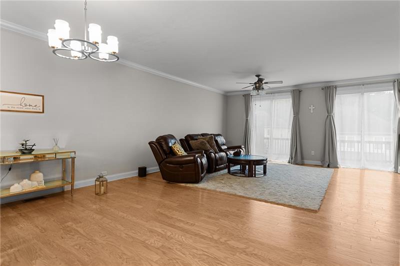 2744 Blakely Drive Northeast Suwanee, GA 30024 - Photo 4 of 45 a living room with furniture and a chandelier