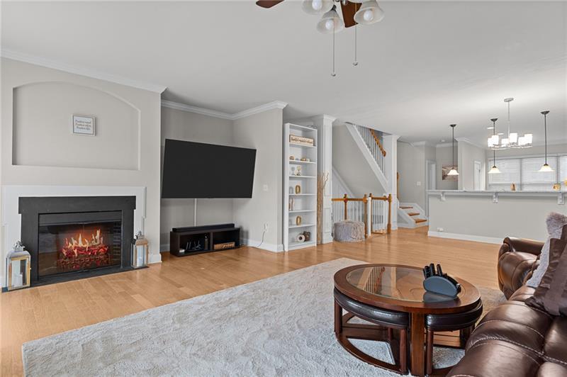2744 Blakely Drive Northeast Suwanee, GA 30024 - Photo 6 of 45 a living room with furniture a flat screen tv and a fireplace
