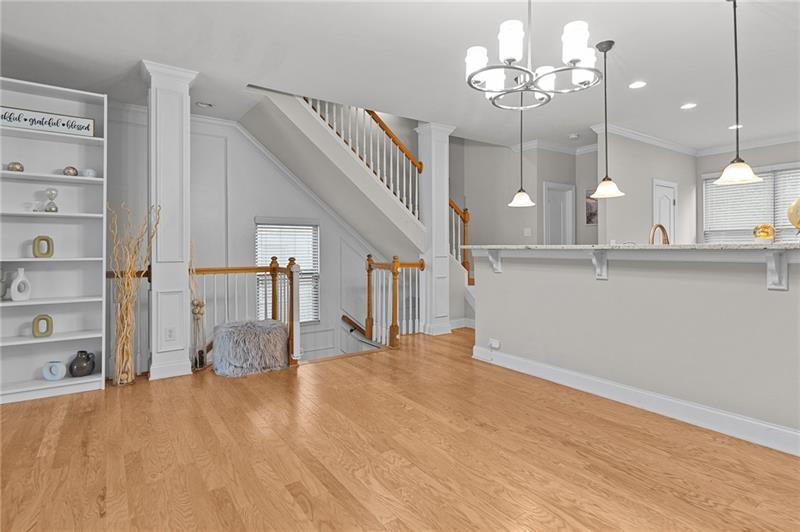 2744 Blakely Drive Northeast Suwanee, GA 30024 - Photo 9 of 45 a view of a livingroom with wooden floor and a ceiling fan