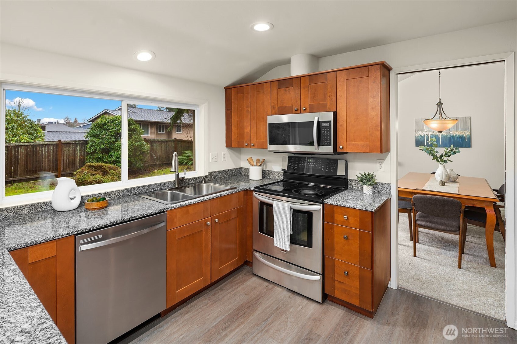 15710 Southeast 46th Way Bellevue, WA 98006 - Photo 11 of 40 a kitchen with stainless steel appliances granite countertop a stove a sink and a microwave